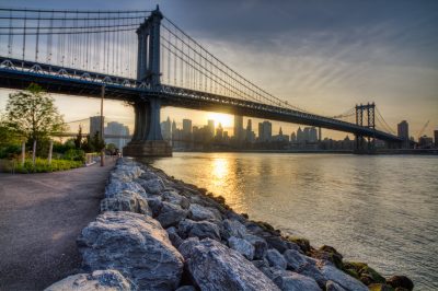 The Manhattan Bridge at Sunset, with the Brooklyn Bridge and the Manhattan skyline in the background.  