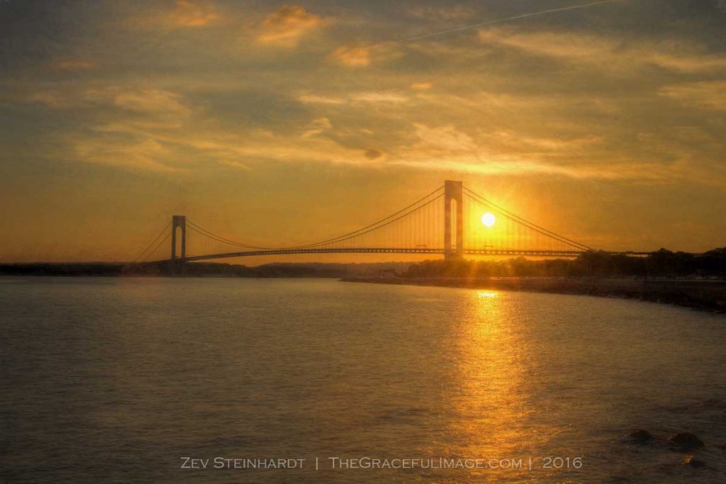 The sun setting behind the Verrazano-Narrows Bridge in Brooklyn on a July evening.