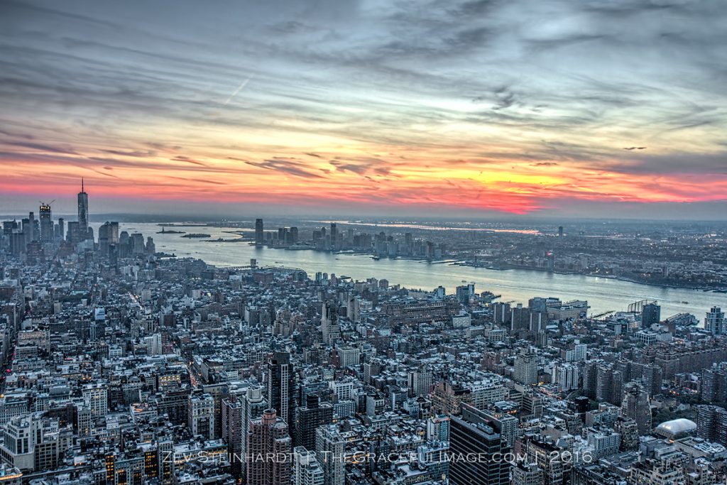 The sun setting over the island of Manhattan and New Jersey